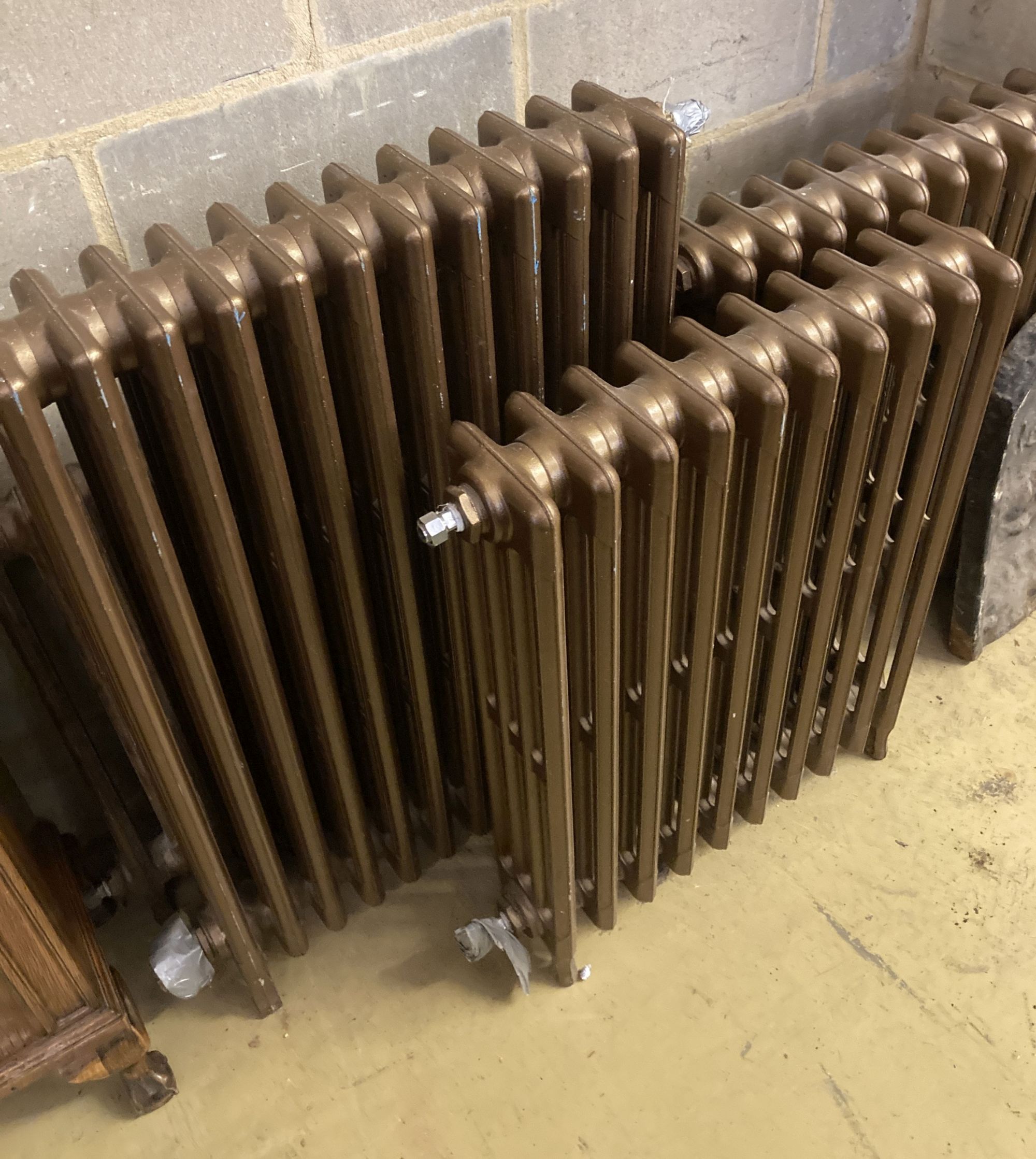 Four cast iron radiators, one vintage, three modern, largest width 64cm, height 91cm